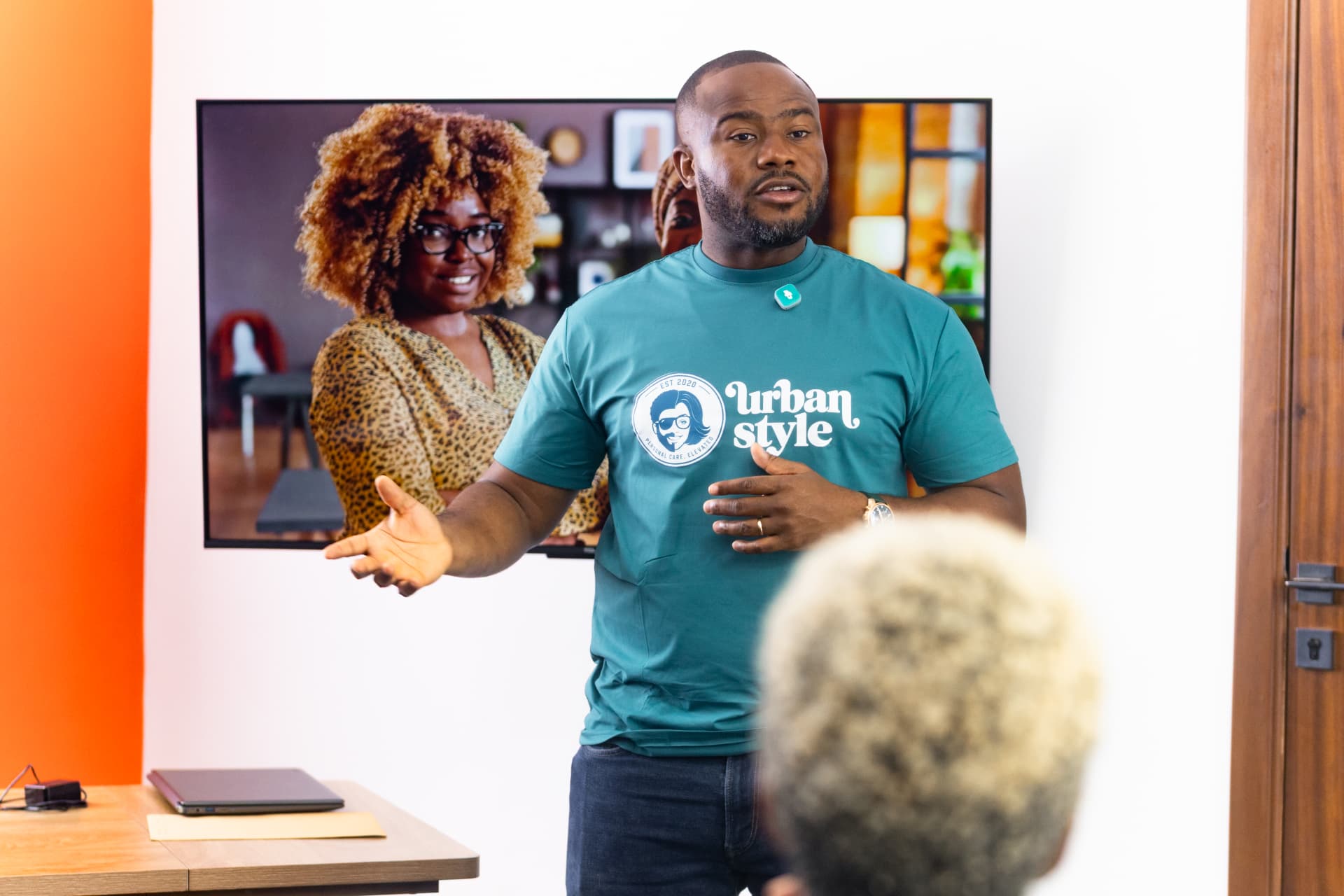Urban Style facilitator in a branded tee welcoming providers to the training session